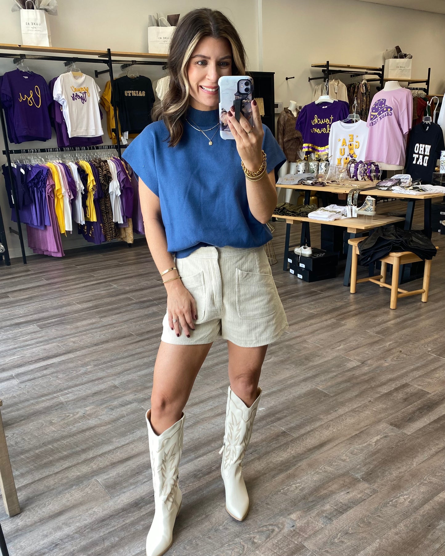 Corduroy ivory shorts with a zipper and two front pockets paired with a blue sweater.