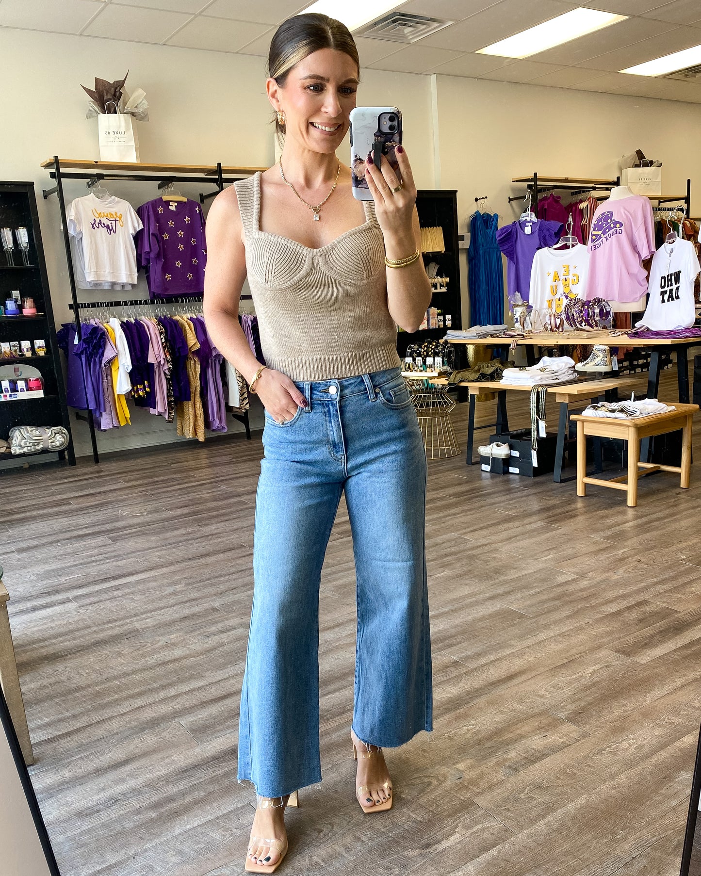 A taupe knit waist length top with a corset style bodice.