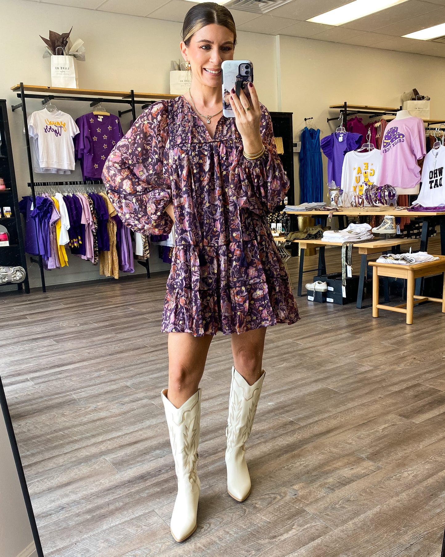 A boho style relaxed fit dress with a tiered bodice, balloon sleeves, and all over floral print.