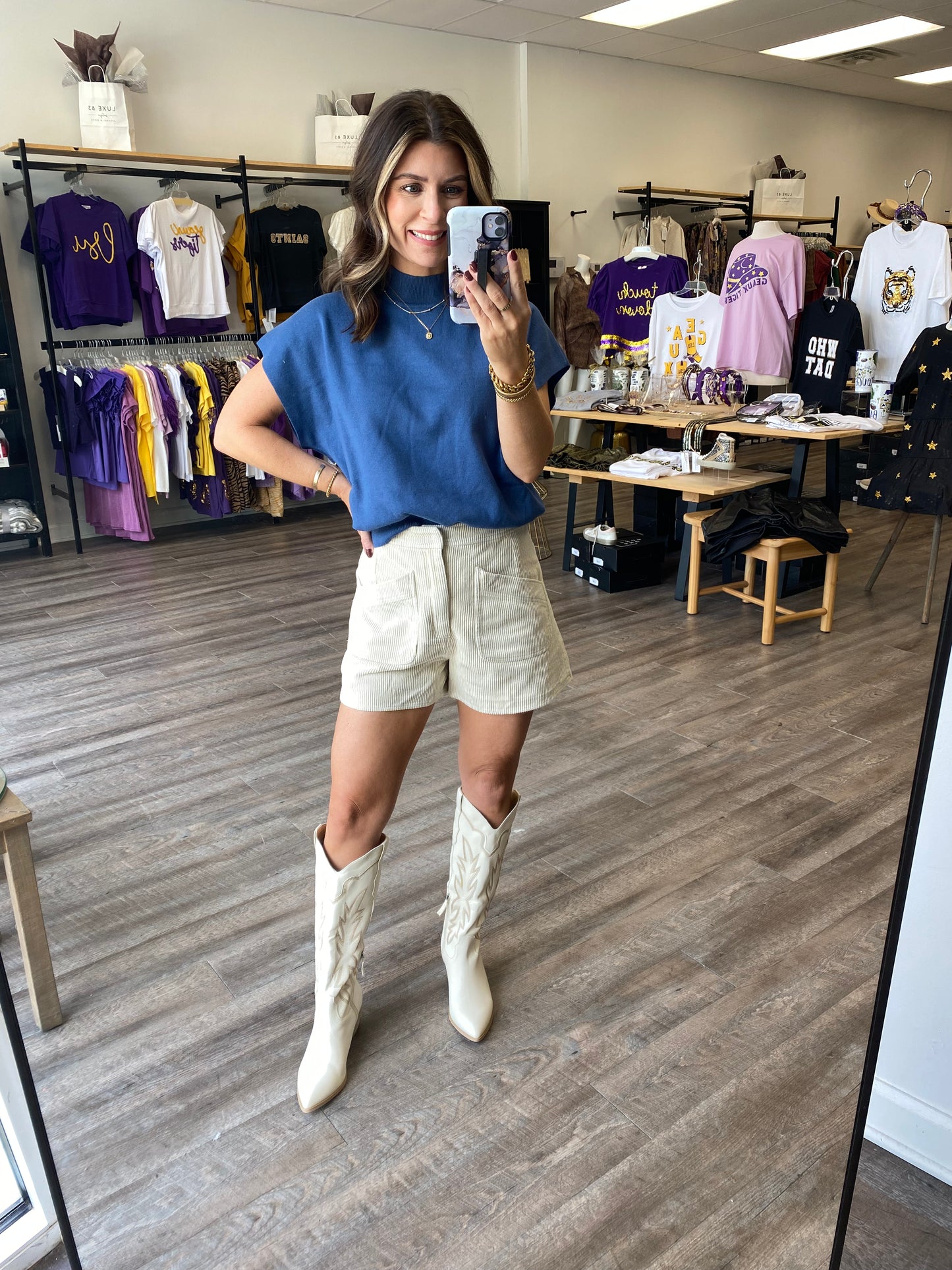 Corduroy ivory shorts with a zipper and two front pockets paired with a blue sweater.