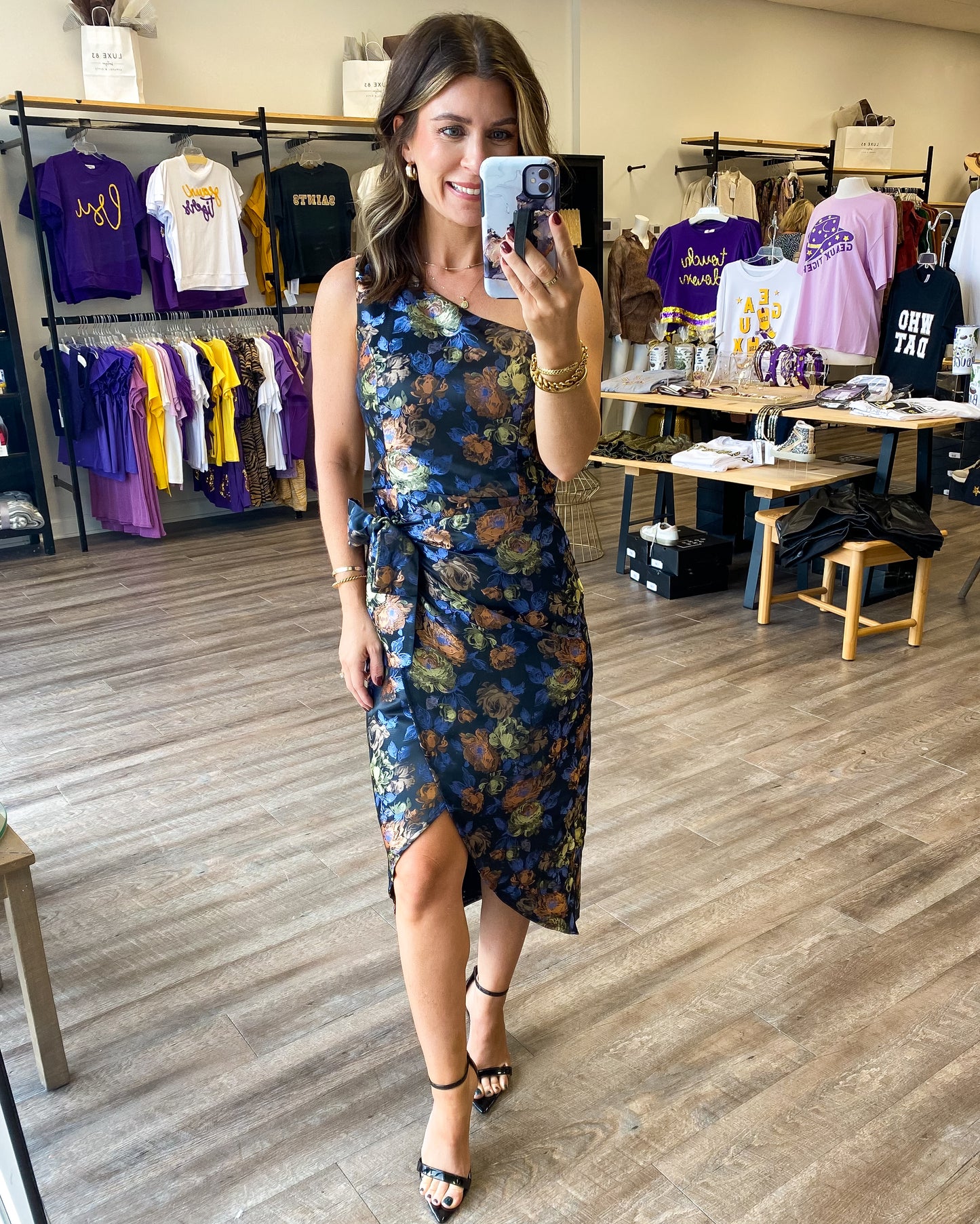 A gorgeous one shoulder dress with an overlapping tie waist. The dress has a beautiful floral print all over and a tie at the waist with a tulip hem.