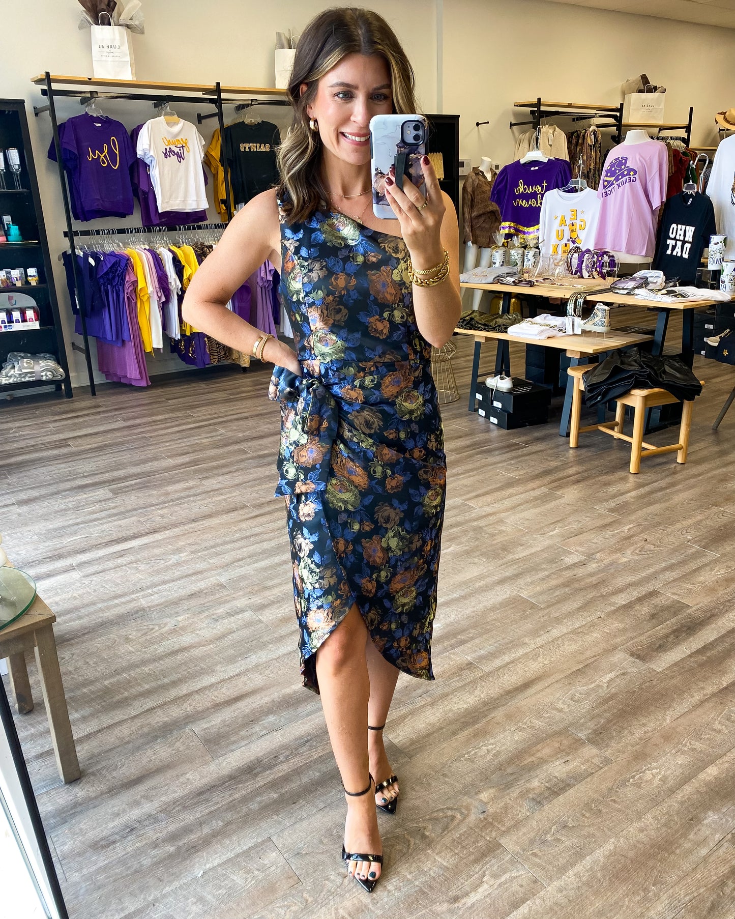 A gorgeous one shoulder dress with an overlapping tie waist. The dress has a beautiful floral print all over and a tie at the waist with a tulip hem.