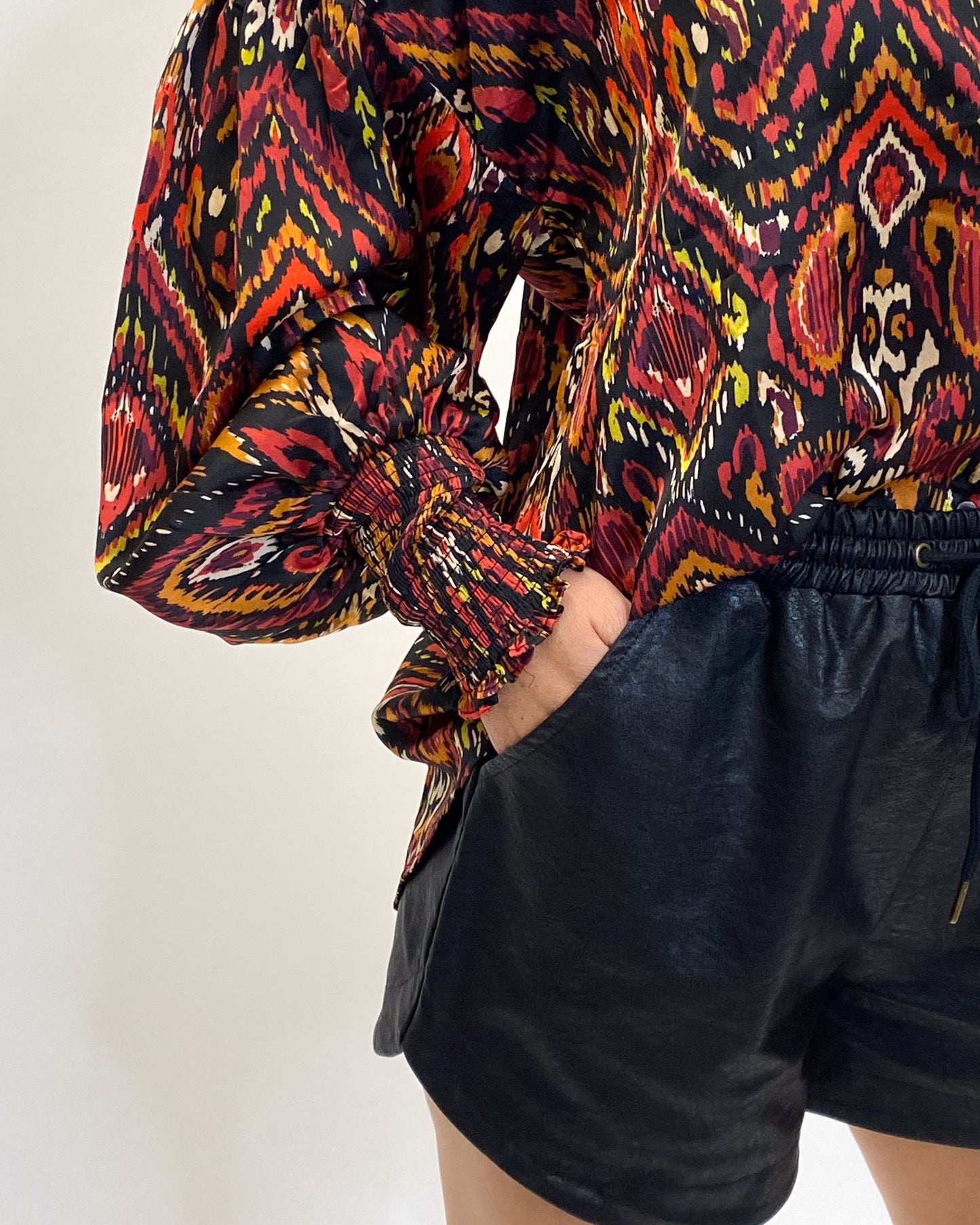 Detailed shot of the printed blouse with smocked wrists.