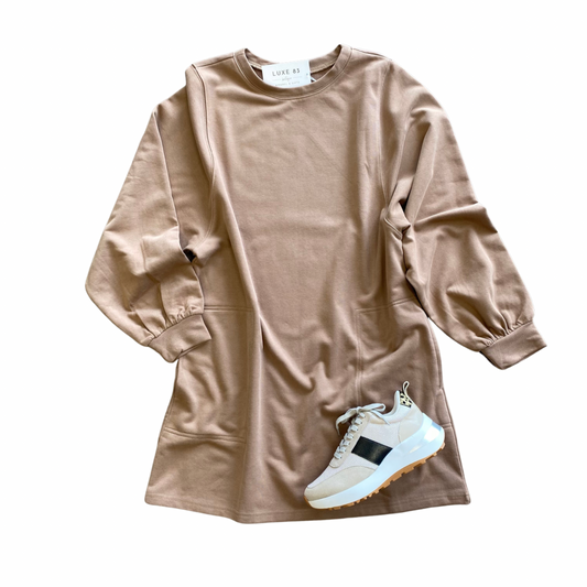 A knee length dress made of sweatshirt material with pockets at the hips in three colors -- camel, charcoal, and green.